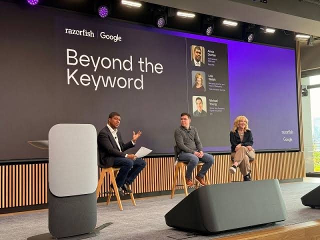 Amos Ductan moderating the 'Beyond the Keyword' Razorfish and Google panel on stage